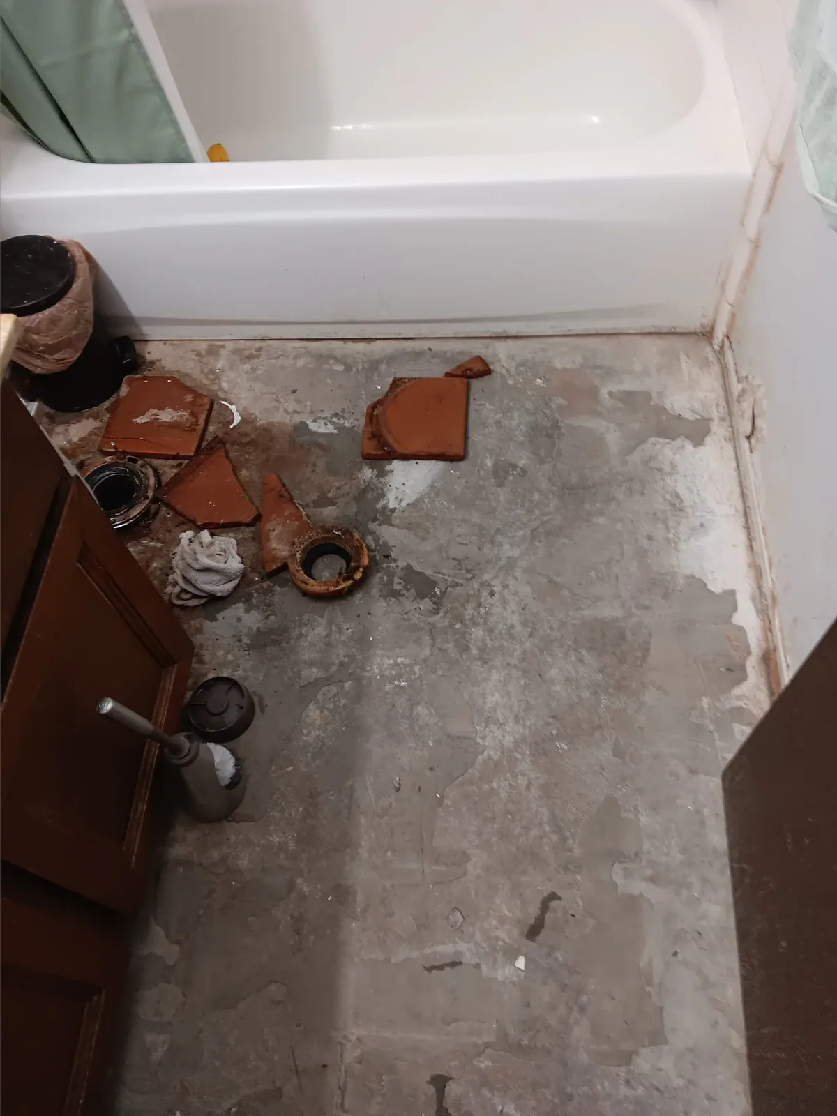 Before: bathroom floor surface exposed during preparation