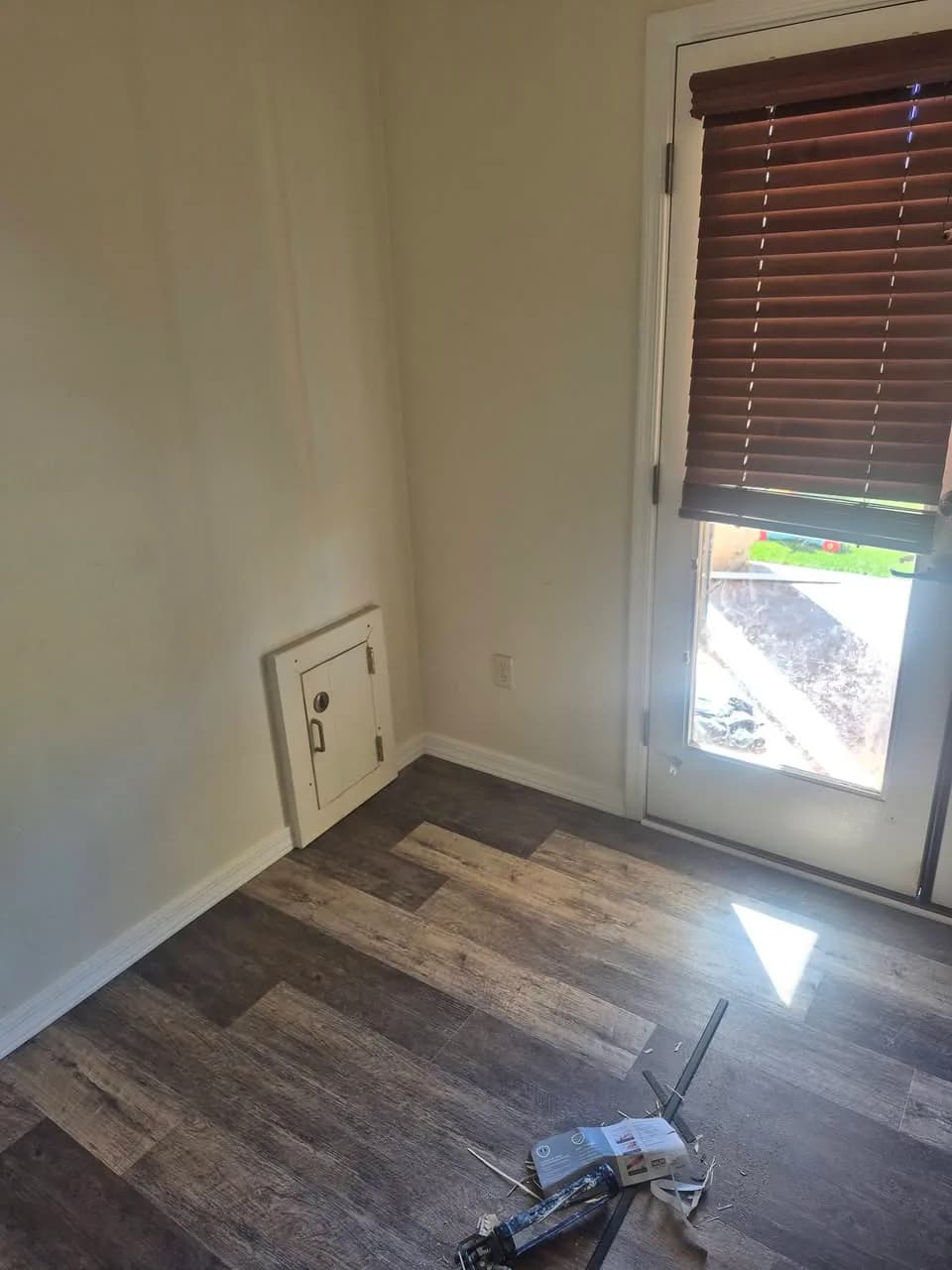 Wood-look plank floor extending toward an exterior door