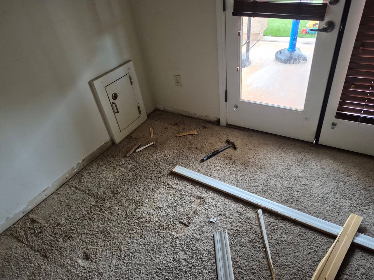 Before: carpeted room with loose trim before removal
