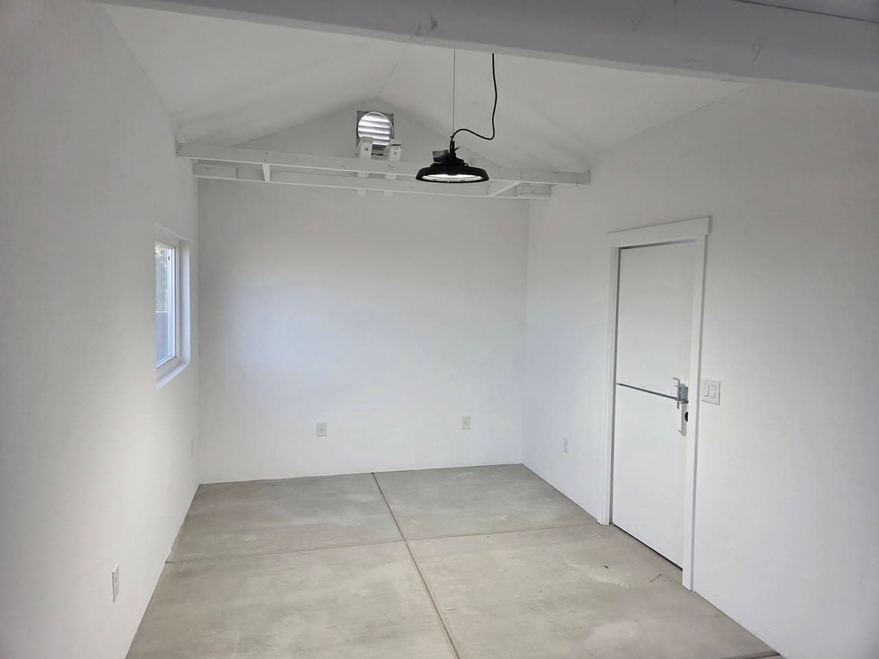 After: bright shed interior with evenly finished walls and trim