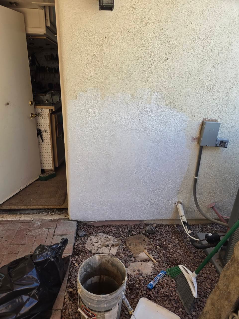 After: patched exterior wall opening with a light unfinished surface
