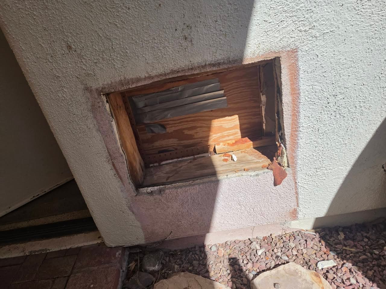 Before: rectangular opening in an exterior stucco wall